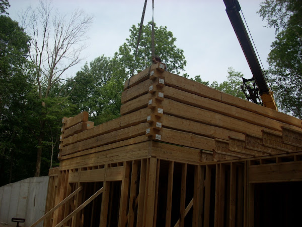 View of the crane working from behind the house