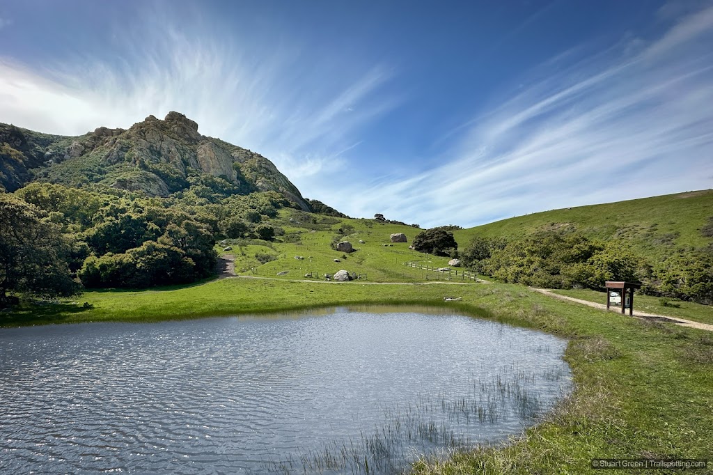Pond in the foreground reflecting the blue sun. Bishop Peak's northern facing flanks stand proud.
