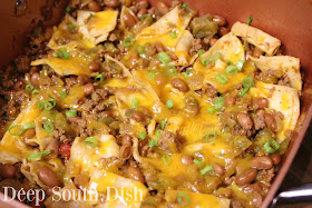 An easy Tex-Mex skillet supper made with ground beef, green chilies, canned pintos, flour tortillas, and seasoned with Sazon, chili powder and cumin. It's like a burrito in a skillet!