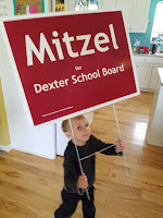 Photo of Rob's youngest child holding a campaign sign