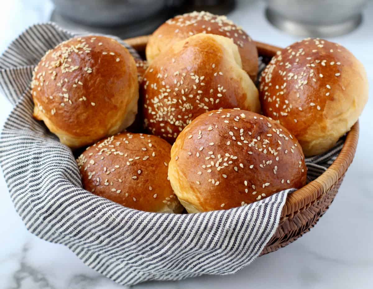 Chinese Coconut Buns (Cocktail Buns) with sesame seeds in a basket.