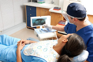 dentist showing x-ray to patient