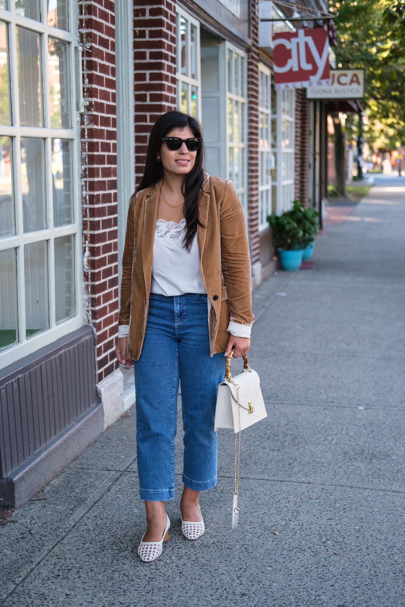 Connecticut style blogger Lydia Abate wearing a camel velvet blazer, straight leg jeans, caned leather pumps, and a croc leather bag for fall