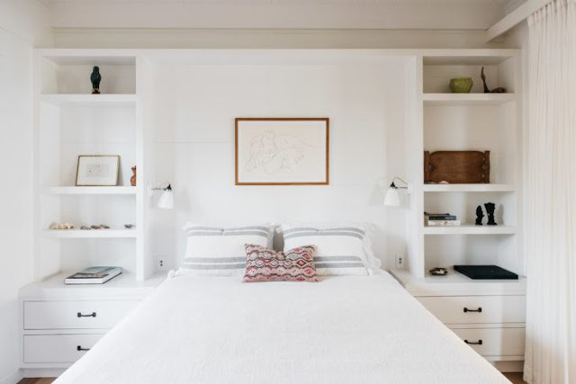 Beautiful bedroom with built-in shelves flanking bed in beautiful oceanfront cottage on Maui - found on Hello Lovely Studio