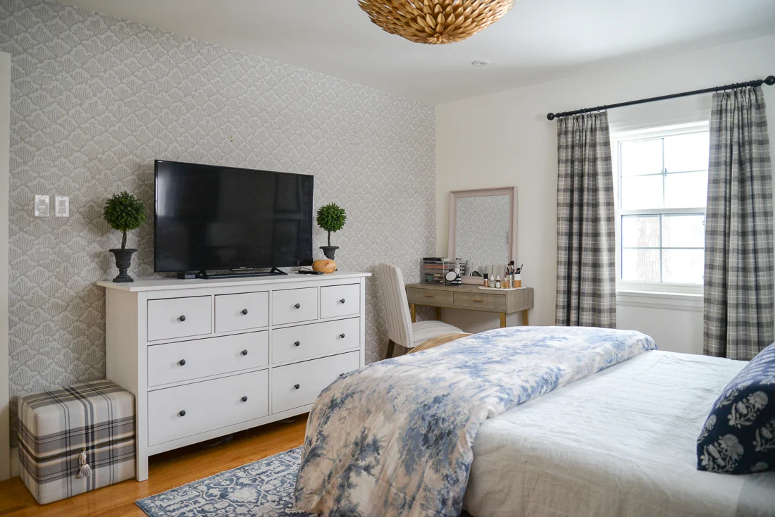 grey accent wall of wallpaper in blue and grey bedroom