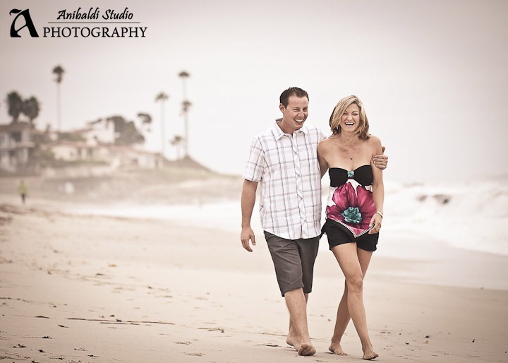 cute couple laughing at beach