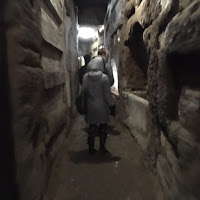 Exploring the many "loculi" in San Callisto catacombs, Rome, Italy