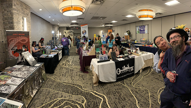 Tables of displays from artists, crafters, Indie authors, and gaming suppliers in the DemiCon33 Dealers Room.