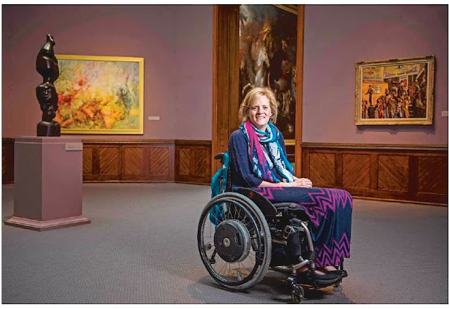 woman in wheelchair in art gallery