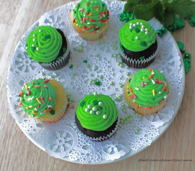 Chocolate stout cupcakes with green frosting and vanilla on a plate