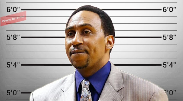 Stephen A. Smith posing in front of a height chart background