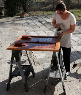 A once again carefully staining the garden furniture