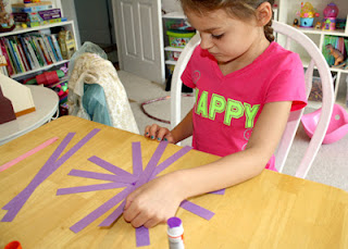 Tessa started her basket by gluing the pieces for the framework in a star pattern.