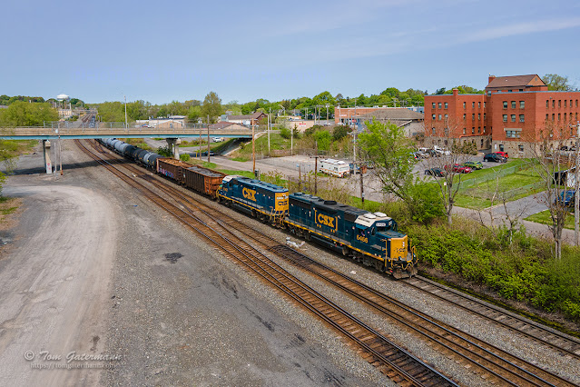 L024-09 is eastbound at CP 286, passing under Burnet Ave. at East Syracuse, NY. The red brick building in the background is the old railroad Y.