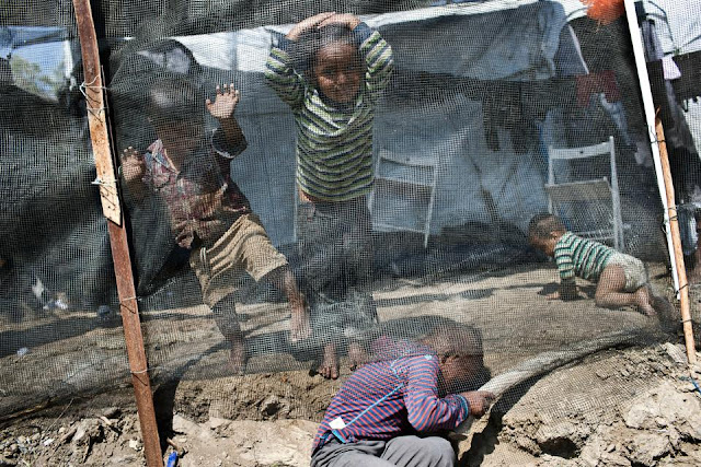 Children play inside the Moria refugee camp on the northeastern Aegean island of Lesbos, Greece, Wednesday, May 2, 2018.