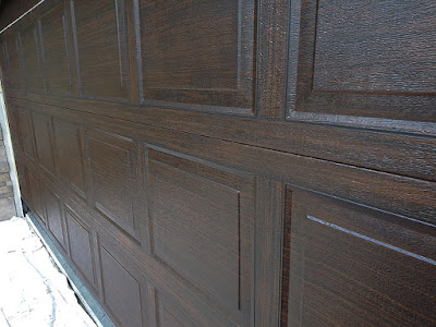 garage door painted to look like dark wood