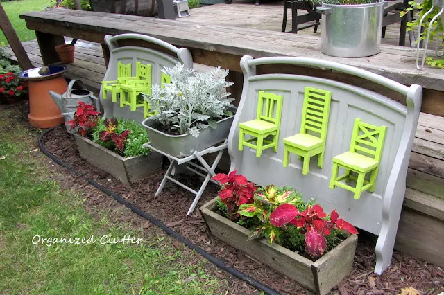 Photo of junk garden planters along the side of the deck.