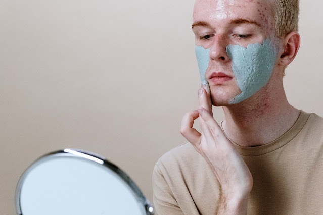 man-in-gray-crew-neck-shirt-with-green-powder-on-face