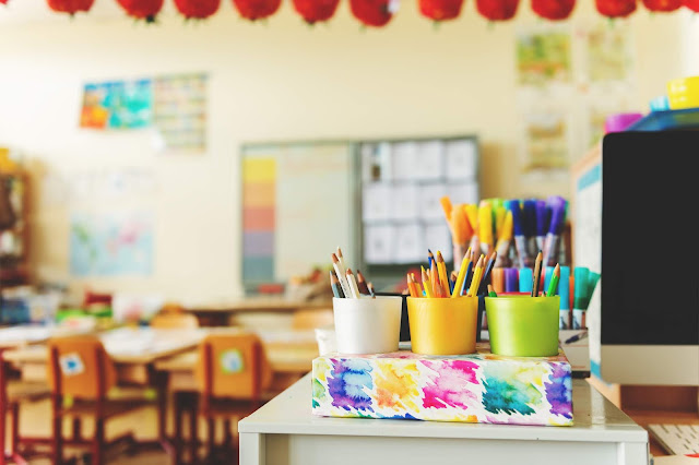 Childrens classroom with pen pots to the forefront of the picture