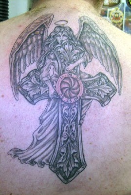 Angel hanging on Celtic cross tattoo