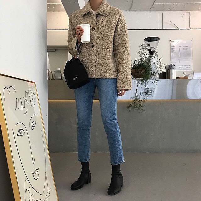 Stylish Coffee Run Outfit Idea From Instagram — Faux Fur Shearling Jacket, nylon Prada bag, cropped jeans, and black ankle boots