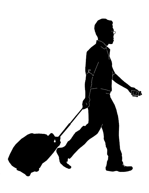 silhouette of an Asian man with a trolley bag