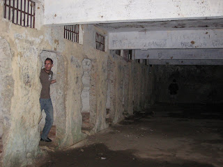 Noah in the ruins of a prison cell on Ilha Grande.