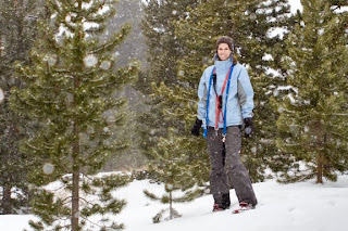 A woman in the snowy woods