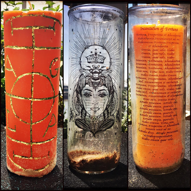 A candle which has an inscription to the Goddess Fortuna on the reusable glass sleeve.