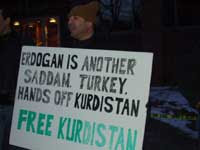 Protestor with sign reading, 'Erdogan is another Saddam. Turkey, hands off Kurdistan. Free Kurdistan' [Credit: Leyla Zana]
