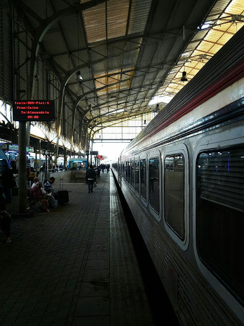Cairo to Alexandria by train, on the platform just before departure. Signage both in English and Arabic.