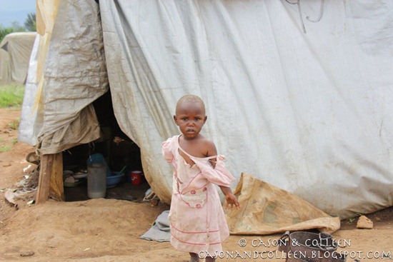 Little girl in front of her tent