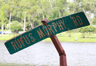 An old road sign right next to the lake