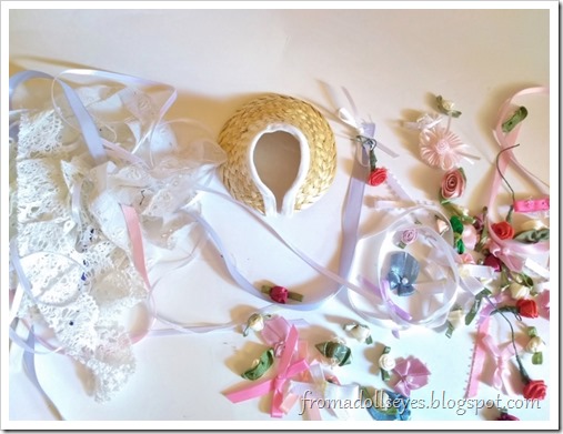 The bonnet is ready to be decorated, surrounded by all sorts of bows, ribbons, flowers and lace.