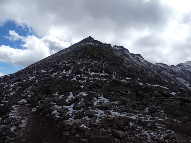 100: dark rock with snow all around