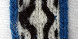 A section of tablet woven band with lower tension on some of the threads on the left