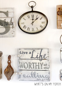 gallery wall with farmhouse clock, wood sign, pulley