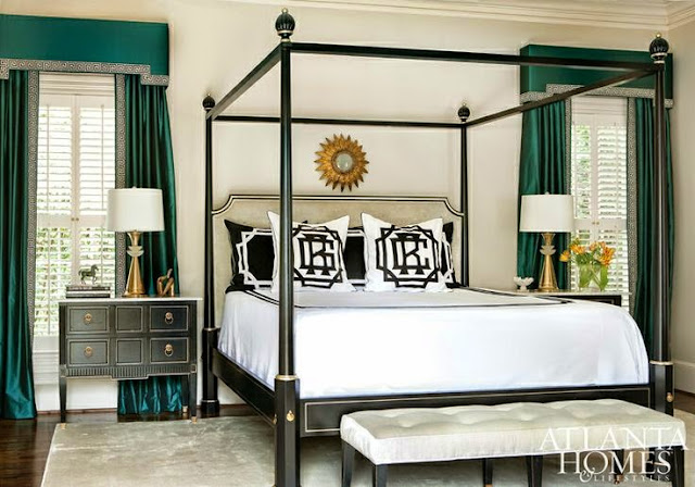 black white and gold bedroom with four poster bed pop of green color