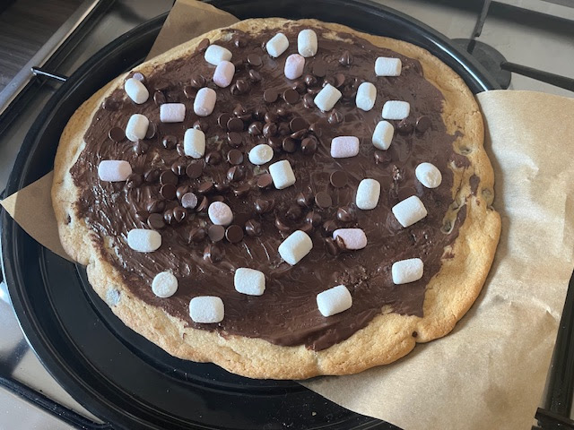 a cookie with marshmallows and chocolate spread on top