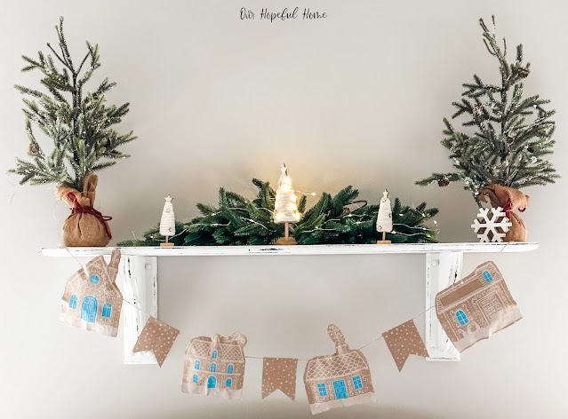 paper bag gingerbread garland hanging on shelf mantel