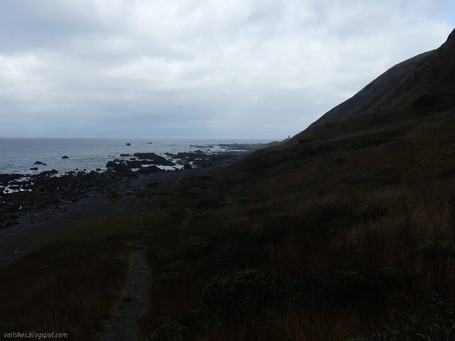 trail descending to beach and lighthouse just visible