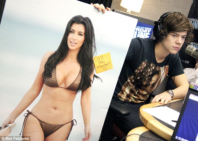  US with this massive poster of Kim Kardashian asking her to call him