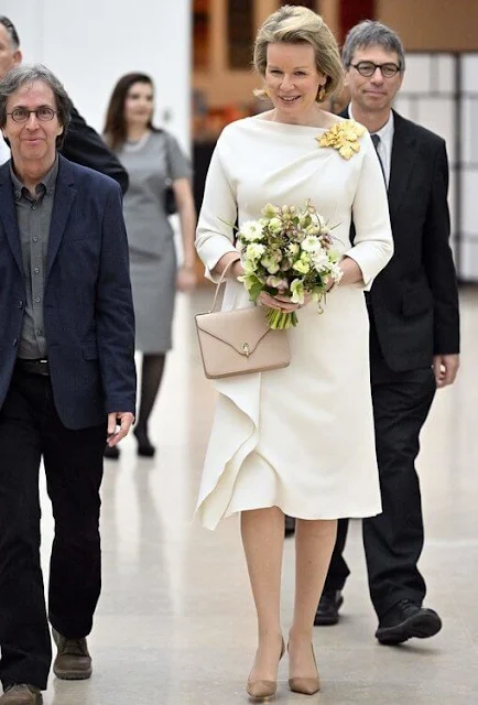 Queen Mathilde wore a white ivory silk ruffle midi dress by Natan.  Leaf gold earrings, flower brooch