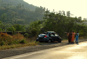 bystanders staring at a smashed car