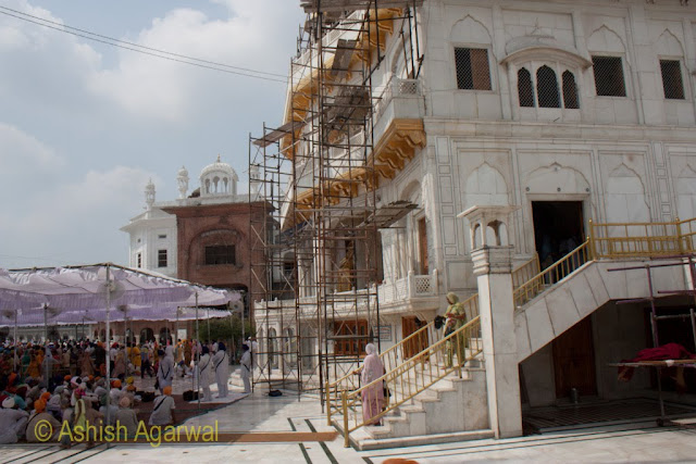 View of a congregation of devotees and the front of the Akal Takht in the Golden Temple complex in Amritsar