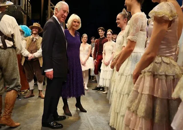 Queen Camilla wore a navy french lace dress over pure silk crepe by Fiona Clare Aldridge. Don Quixote performance