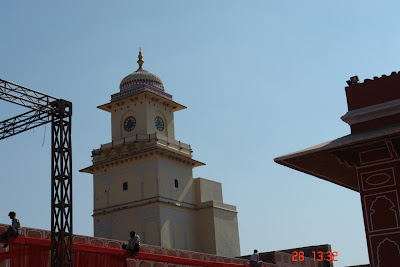 Photo of Clocktower in the Jaipur City Palace along with workmen working on a decoration