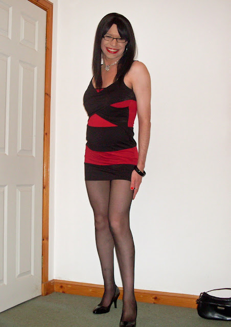 Happy crossdresser in black pantyhose and heels