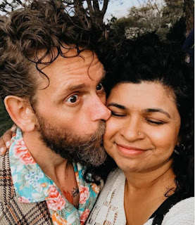 Picture of Aarti Sequeira kissed by her spouse Brendan McNamara