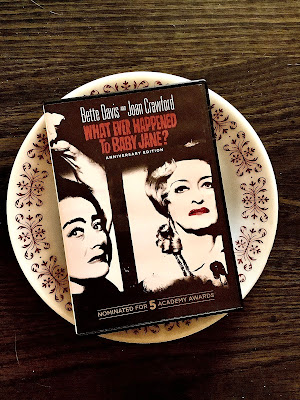 The dvd of What ever happened to baby Jane rests on a dinner plate.